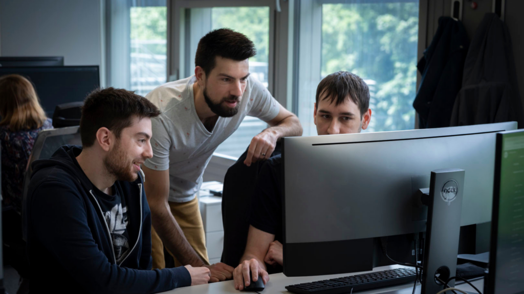 BCE team members collaborating on software development and technology projects in a modern office environment.