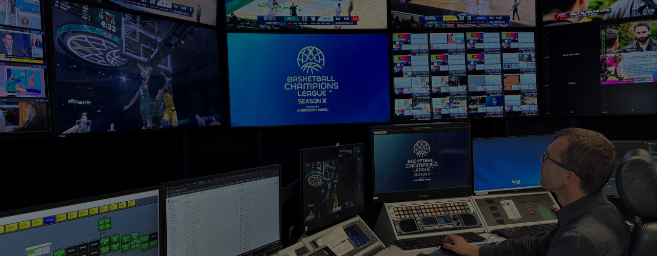 BCE’s Network Operations Center (NOC) monitoring live Basketball Champions League (BCL) matches and managing content distribution through a wall of screens displaying live feeds and technical workflows.